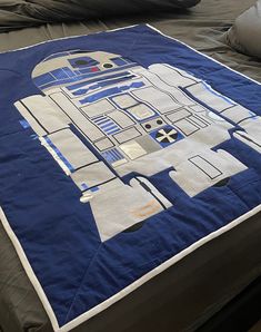 a bed with a star wars quilt on it