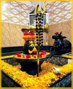 there is a decorative fountain with flowers on the bottom and an ornamental statue next to it