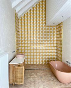 a bathtub and sink in a bathroom with yellow wallpaper