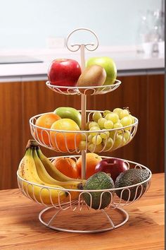 three tiered fruit tray with apples, bananas and avocados