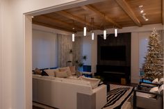 a living room filled with furniture and a christmas tree in the middle of the room