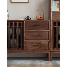 a wooden dresser sitting next to a bookshelf