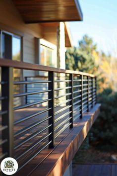 a close up of a metal railing on a house with trees in the back ground