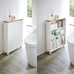 two white toilets sitting next to each other on top of a wooden floor in a bathroom