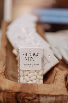 a wooden tray topped with white candies on top of a table