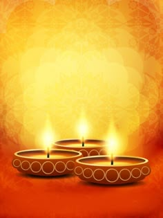 three lit candles on an orange background with snowflakes in the backgroud