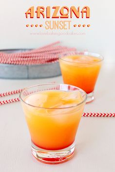 two glasses filled with orange juice on top of a table