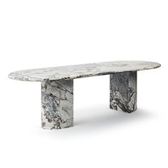 a white marble bench sitting on top of a wooden table