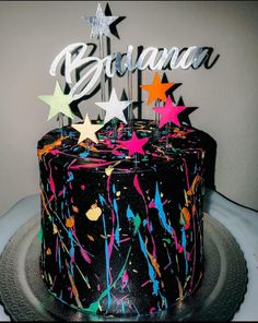 a birthday cake decorated with stars and confetti