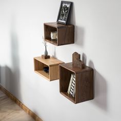 three wooden shelves are hanging on the wall