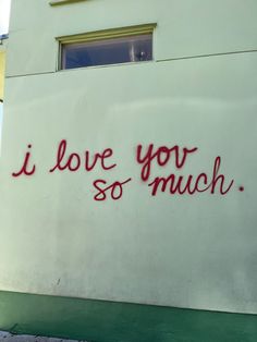 graffiti on the side of a building that says i love you so much with red writing