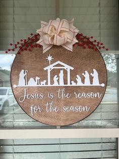 a wooden sign that says jesus is the reason for the season