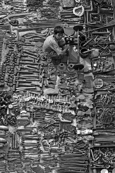 black and white photograph of an assortment of tools on display in a store window, taken from above