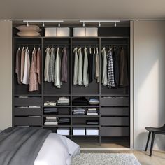 an organized closet with clothes and shoes on hangers