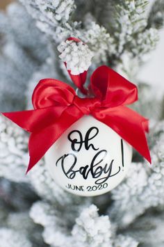 a baby's first christmas ornament hanging from the top of a tree