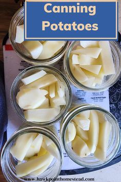 four glass jars filled with sliced cheese sitting on top of a table next to a blue sign that says canning potatoes