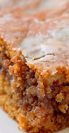 a close up of a piece of cake on a plate with frosting and icing