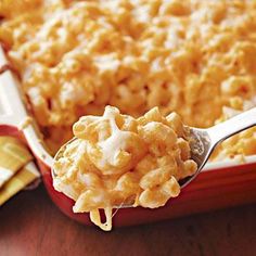 a red casserole dish with macaroni and cheese