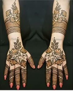 two hands with henna tattoos on them