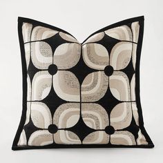 a black and white pillow with circles on it