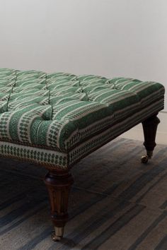 an upholstered bench sitting on top of a carpeted floor