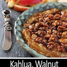 an apple pie with walnuts on top and the words kahlua walnut crust