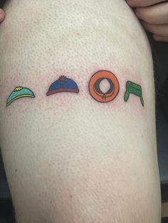 a person with a tattoo on their leg that has different symbols and colors around them