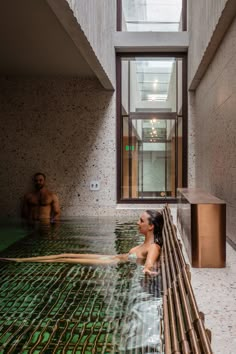 a woman sitting in the middle of a swimming pool