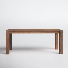 a wooden table sitting on top of a white floor