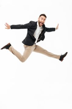 a man is jumping in the air with his arms out and legs spread wide open