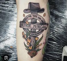 a person with a hat and flowers on their leg is wearing a tattoo that reads, i need are those who want arthror morgan