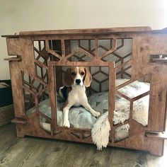 a dog is sitting in his bed made out of wood