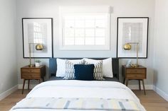 a bedroom with two framed pictures on the wall and a bed in front of it