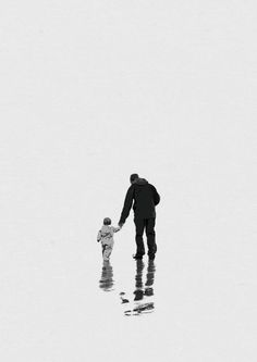 a man and child are walking in the snow