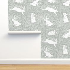 a wallpaper with rabbits on it and a white frame in front of the wall