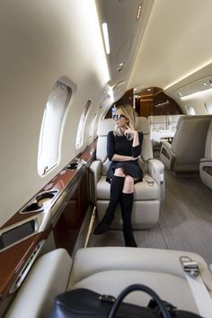 a woman sitting in the aisle of an airplane