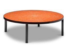 an orange table with black legs and a circular design on the top, against a white background