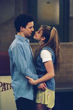 a young man and woman standing next to each other