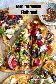 a pizza with lots of toppings sitting on top of a cutting board