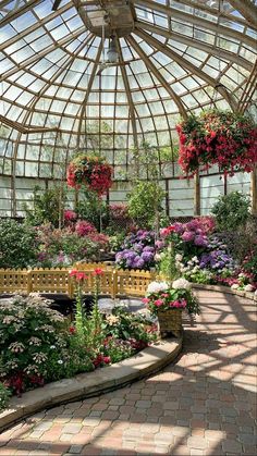 the inside of a large greenhouse with lots of flowers