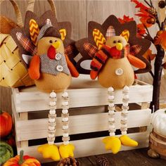 two stuffed turkeys sitting on top of a wooden crate