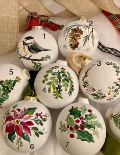 christmas ornaments are arranged on top of each other with numbers and designs painted on them