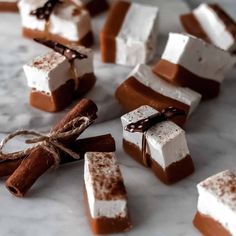 marshmallows and chocolate are arranged on a marble surface