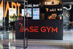 the inside of a gym with an orange and black sign that says base gym on it