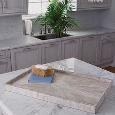 a tray with a piece of bread on it sitting on a counter top in a kitchen