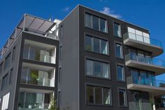 an apartment building with balconies on the second floor and glass balconies on the third floor