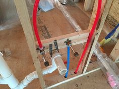 pipes and fittings on the floor in a house under construction