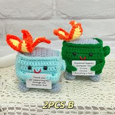 two small crocheted items sitting next to each other on top of a table