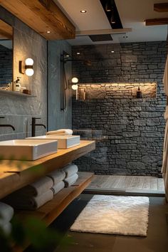 a bathroom with stone walls and flooring next to a walk - in shower area