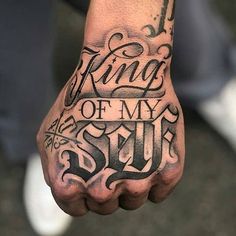 a man's hand with the words king of my soul tattooed on his left arm